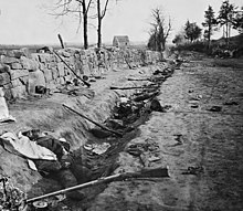 Trench with abandoned rifles and dead men