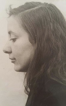 A 1945 sepia portrait photograph of Musine Kokalari, taken from Kokalari's left side.