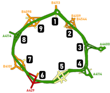 Line-drawn map showing the ring road in green and the numbered junctions, including the layout of each junction and small sections of roads leading away from the junction, with roads coloured green, orange, red or yellow depending on the class of road