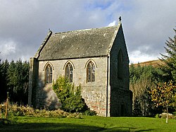 A short, relatively tall chapel, with three arched windows in the near face, and a taller similar window in the face receding to the right