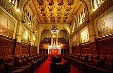 Canadian Senate chamber long hall with two opposing banks of seats with historical paintings