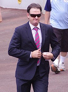 Mark Waugh is seen wearing sunglasses and a dark-coloured blazer.