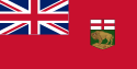 A red flag with a large Union Jack in the upper left corner and a shield, consisting of St. George's Cross over a left-facing bison standing on a rock, on the right side