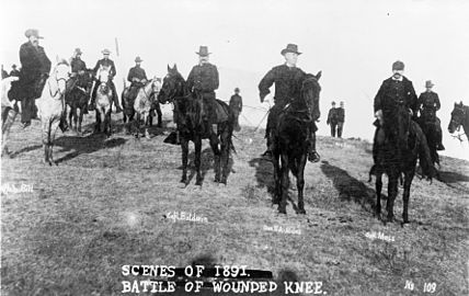 Buffalo Bill, Capt. Baldwin, Gen. Nelson A. Miles, Capt. Moss, and others, on horseback, on battlefield of Wounded Knee.