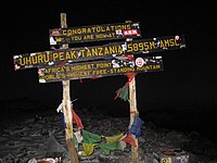 Sign at Uhuru peak, indicating to trekkers that they have reached the top.