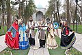 An Iranian family celebrating Nowruz in their traditional ethnic attire