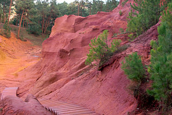 Red ochre cliffs near Roussillon in France. Red ochre is composed of clay tinted with hematite. Ochre was the first pigment used by man in prehistoric cave paintings.