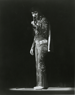 Photograph of Presley singing into a microphone