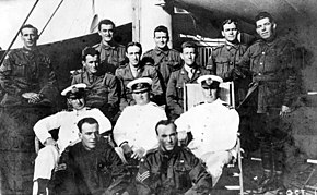 a black and white photograph of a group of men in uniform on a ship