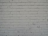 A white brick wall, similar in appearance to that in the film