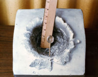 A 7-gram object (shown in centre) shot at 7 km/s (23,000 ft/s), the orbital velocity of the ISS, made this 15 cm (5.9 in) crater in a solid block of aluminium.