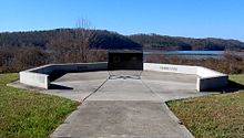 Concrete monument with view of reservoir in the background