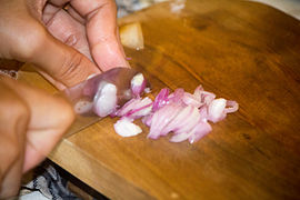 Shallots being chopped for satay