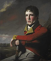 A young, rosy-cheeked man in the red uniform of the British Army.