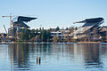 Husky Stadium, University of Washington, seen across Union Bay. The original stands were built 1920 by the Puget Sound Bridge and Dredging Company; major modifications included the cantilevered covered south stands (1950), similar stands on the north side (1987), and the major reconstruction 2011-2013, in progress in this photo.