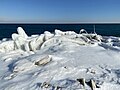 Rubble and other human-made artifacts covered by winter ice at the Leslie Spit.