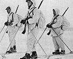 Norwegian volunteer soldiers in Winter War, 1940, with white camouflage overalls over their uniforms