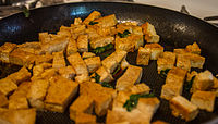Tofu being fried