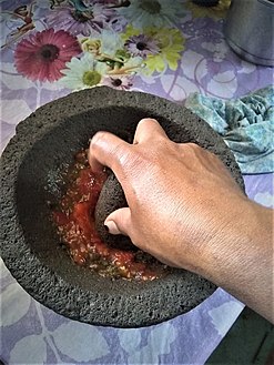 Grinding in a molcajete. San Juan Achiutla, Oaxaca, México.