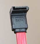 A seven-pin SATA data cable (left-angled version of the connector)