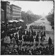 Troops marching while the crowd is watching on Pennsylvania Avenue NW
