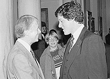 A monochrome image of Carter shaking hands with Bill Clinton
