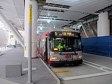 A bus under a large building