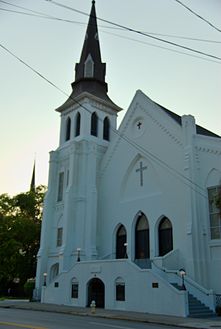 A white-painted church at sunset.
