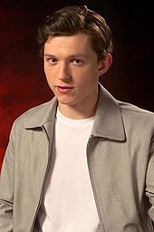Tom Holland is looking directly towards the camera