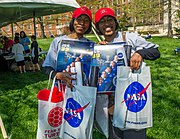 Visitors to Maryland Day displaying NASA Goddard swag, 2014