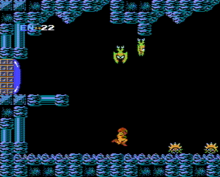 A video game screenshot of a protagonist in a powered exoskeleton, traveling through a cave while winged monsters fly down from the ceiling.