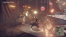 A black-clad woman fights machine enemies in a ruined industrial environment.