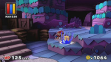 A nighttime, hilly grassland setting designed to be constructed out of paper. Mario is hitting his hammer on the ground, coloring it with blue paint.
