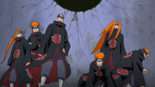A group of six red-haired characters wearing black clothes who have multiple piercings